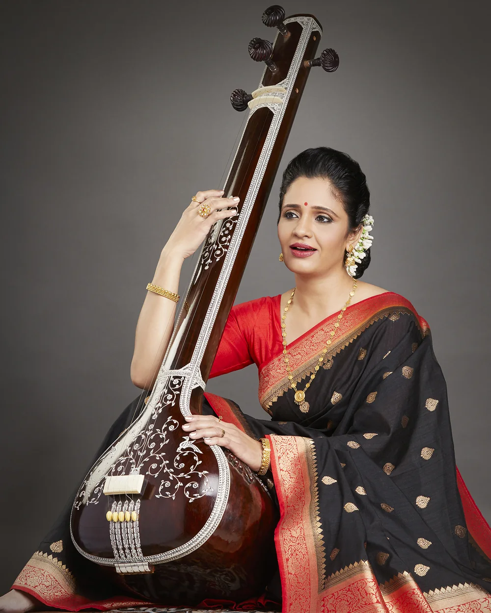A SwarSampada vocalist performing live at an event